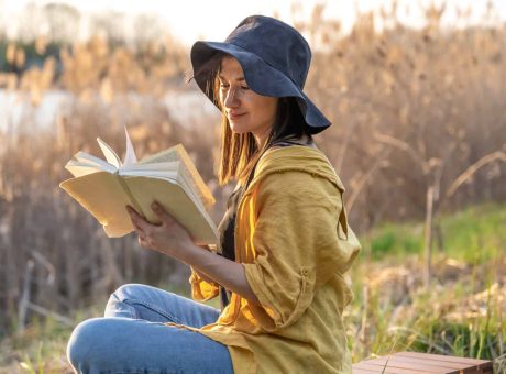 stylish girl with a book in her hands reads at sunset .jpg